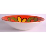 A RETRO POOLE POTTERY FRUIT BOWL painted with yellow and green motifs. 1Ft 1.5ins diameter.