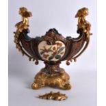 A 19TH CENTURY METTLACH POTTERY TWIN HANDLED BOWL with ormolu cupid mounts, decorated in relief with