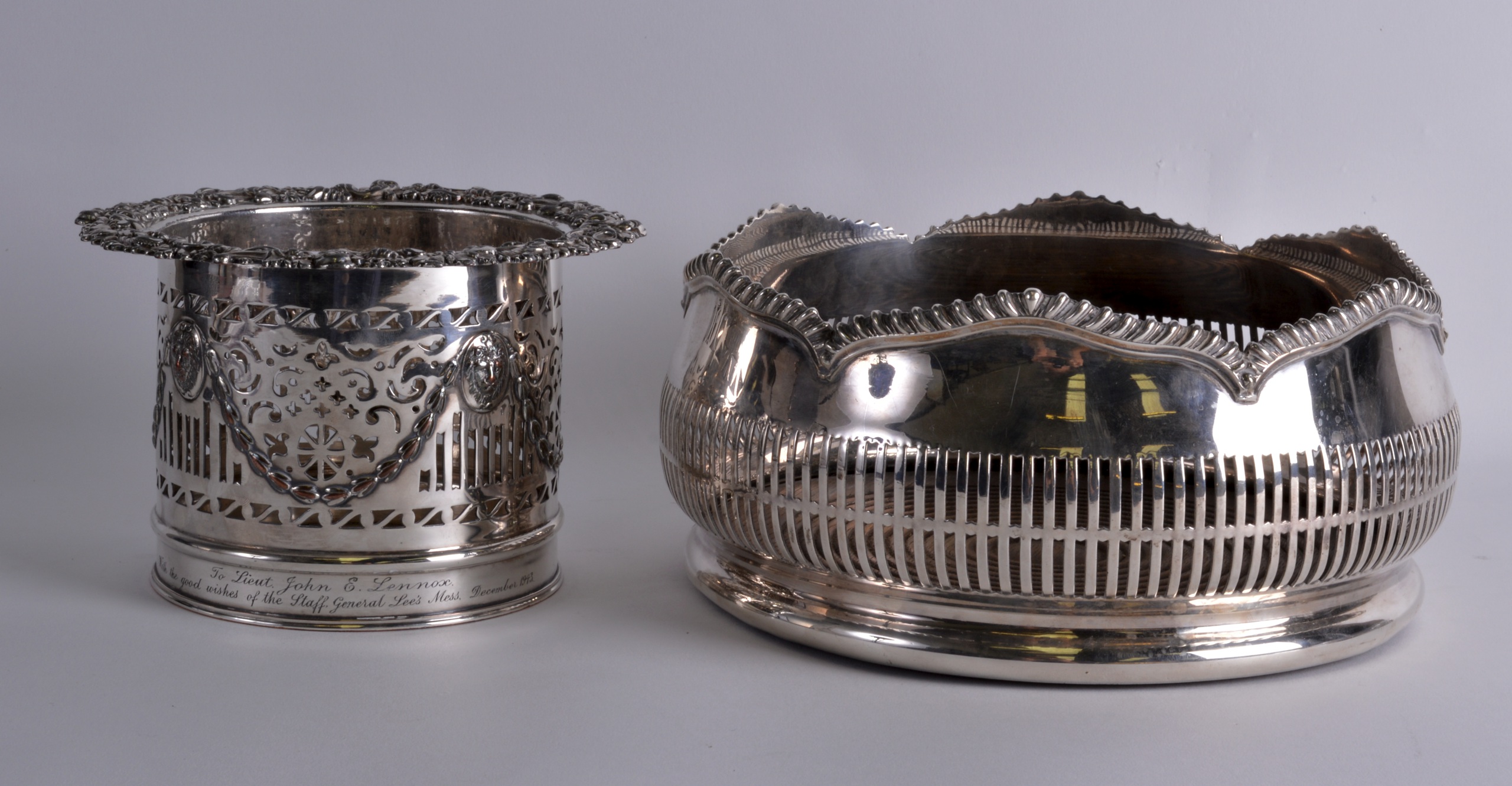 A VICTORIAN SILVER PLATED COASTER together with a larger silver plated coaster. 7Ins & 8.5ins