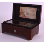 A SMALL MID 19TH CENTURY WALNUT MUSIC BOX playing six airs. 6.75ins wide.