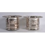 A PAIR OF LATE VICTORIAN/EDWARDIAN SILVER PLATED WINE COASTERS decorated in relief with lion