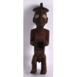 AN AFRICAN CARVED AND POLYCHROMED FIGURE OF A MALE modelled with an open stomach. 9.5ins high.