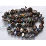 AN UNUSUAL EARLY CARVED GLASS BEAD NECKLACE possibly Roman, containing numerous brightly coloured