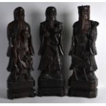 A LARGE SET OF THREE CHINESE CARVED HARDWOOD IMMORTALS incised with motifs and vines, upon square