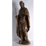 A GOOD 18TH CENTURY CARVED EUROPEAN WOOD FIGURE OF A SAINT modelled holding a staff, upon an oval