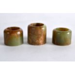 A CHINESE CARVED JADE ARCHERS RING 20th Century, together with two others. (3)