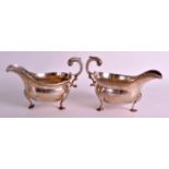 A LARGE PAIR OF GEORGE III SILVER SAUCEBOATS with scrolling rococo handle, supported upon shell