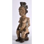 A POLYCHROMED AFRICAN FIGURE OF A FEMALE modelled with exposed breasts. 9.5ins high.