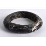 A LARGE CHINESE QING DYNASTY CARVED HARDSTONE BANGLE. 4Ins wide.
