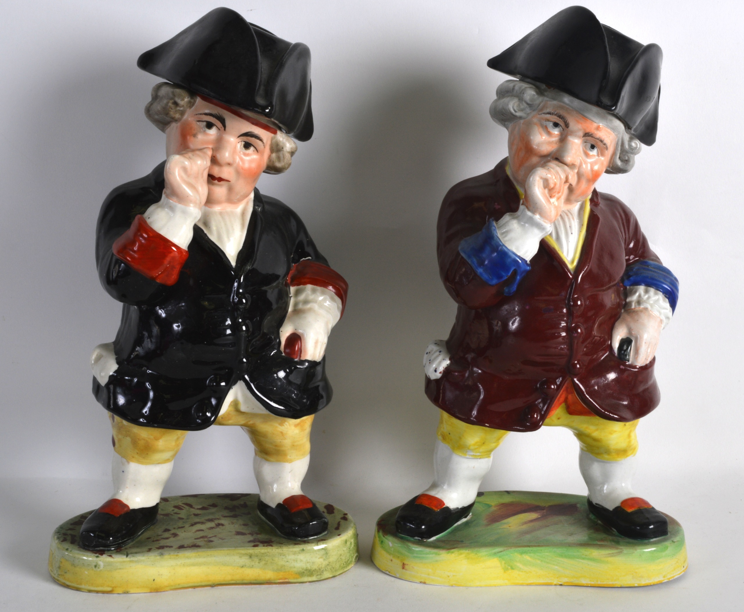 A PAIR OF 19TH CENTURY STAFFORDSHIRE FIGURES OF GENTLEMAN one with a removable cover, each