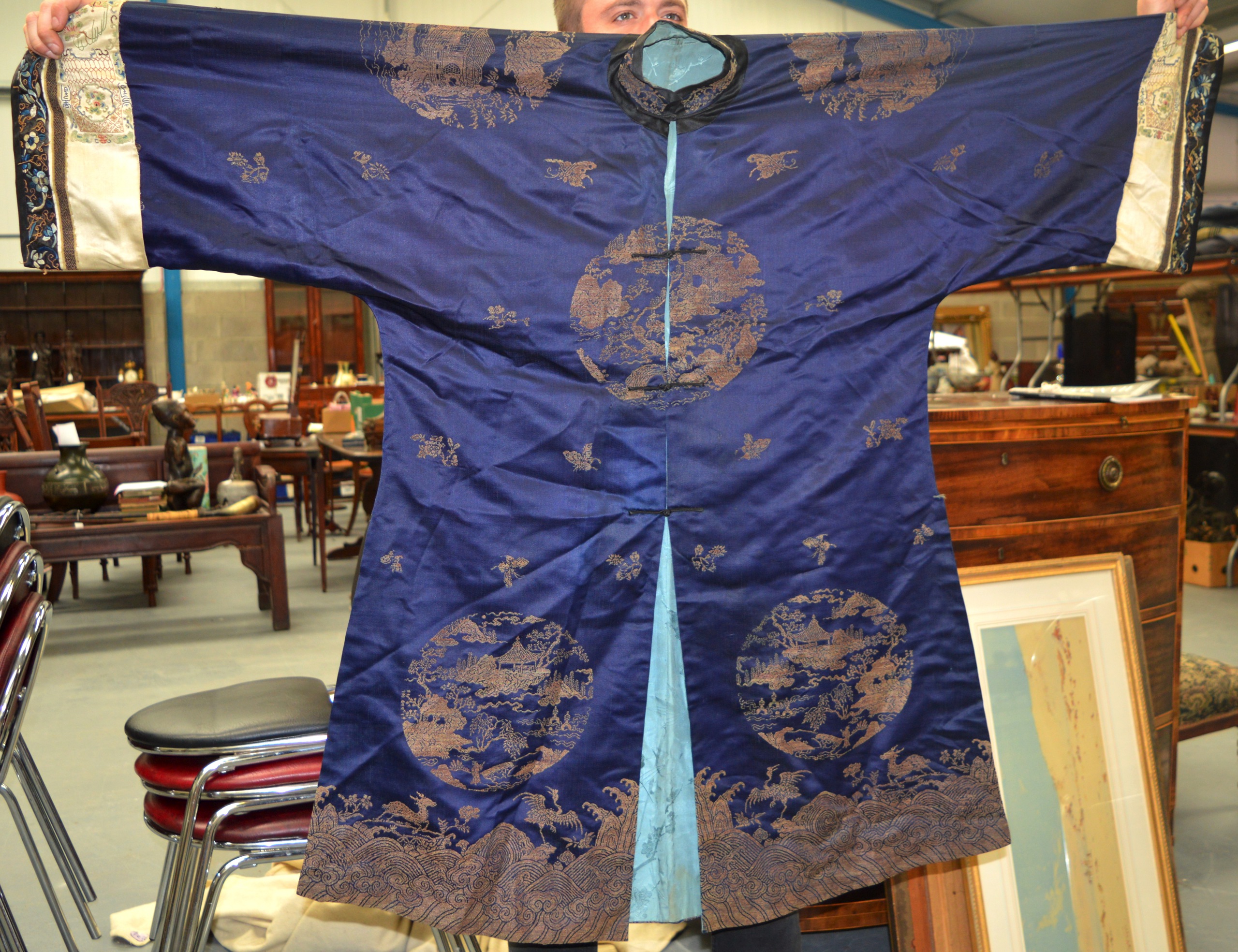 AN UNUSUAL 19TH CENTURY CHINESE BLUE SILKWORK ROBE decorated with insects and landscapes, the