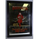 A LARGE VINTAGE FRAMED ADVERTISING 'BEEFEATER GIN' MIRROR. 3Ft x 2ft 2ins.