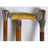 A LATE VICTORIAN IVORY HANDLED WALKING CANE together with a silver topped cane & another. 2Ft
