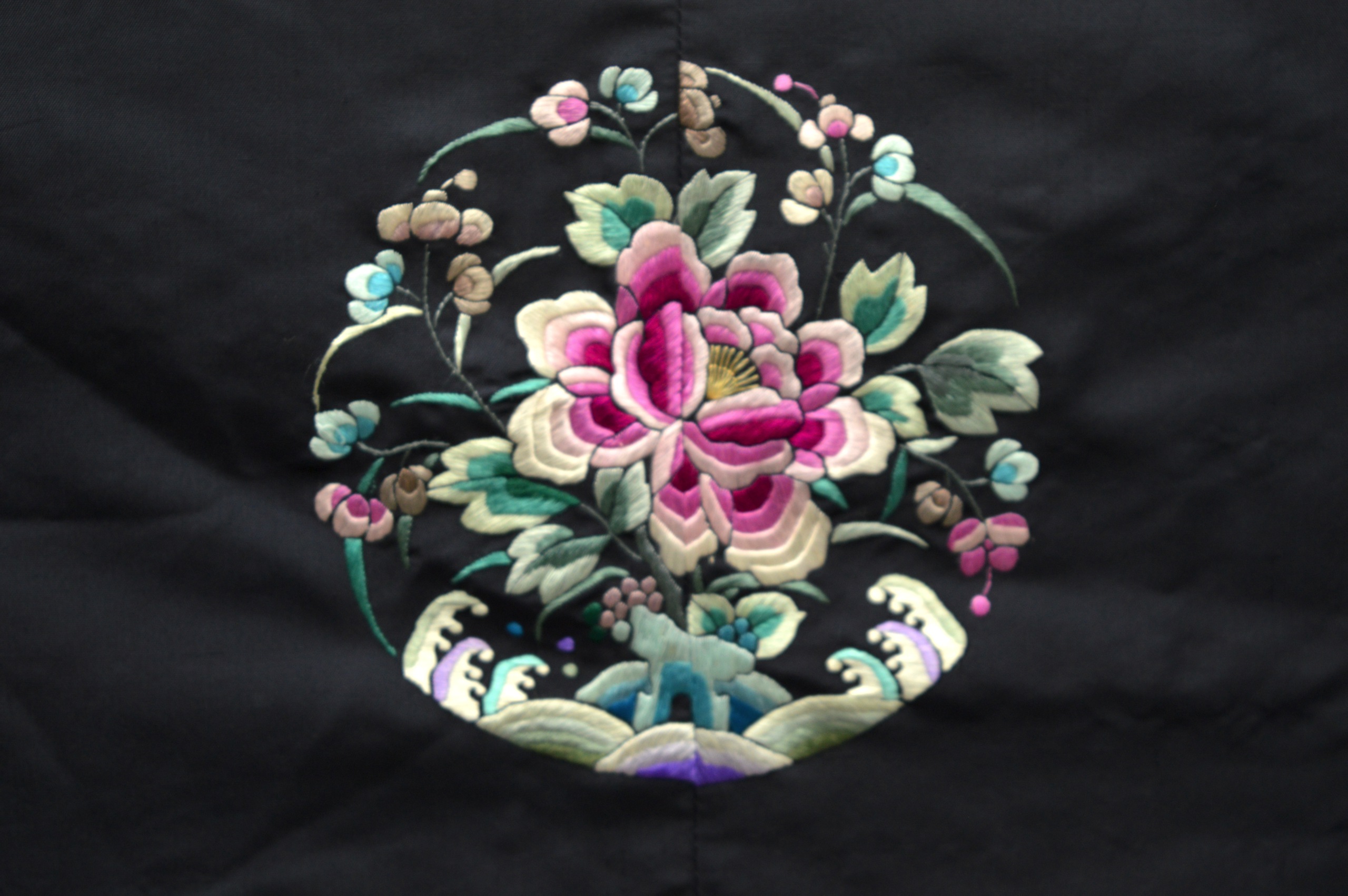 AN EARLY 20TH CENTURY CHINESE BLACK SILKWORK ROBE decorated with panels of flowers, over crashing - Image 6 of 6