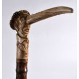 AN UNUSUAL VICTORIAN CARVED ANTLER 'PUNCH' HEAD WALKING CANE modelled with an elongated nose and