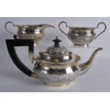 A LATE 19TH CENTURY INDIAN SILVER THREE PIECE TEASET decorated with scenes of lions and elephants