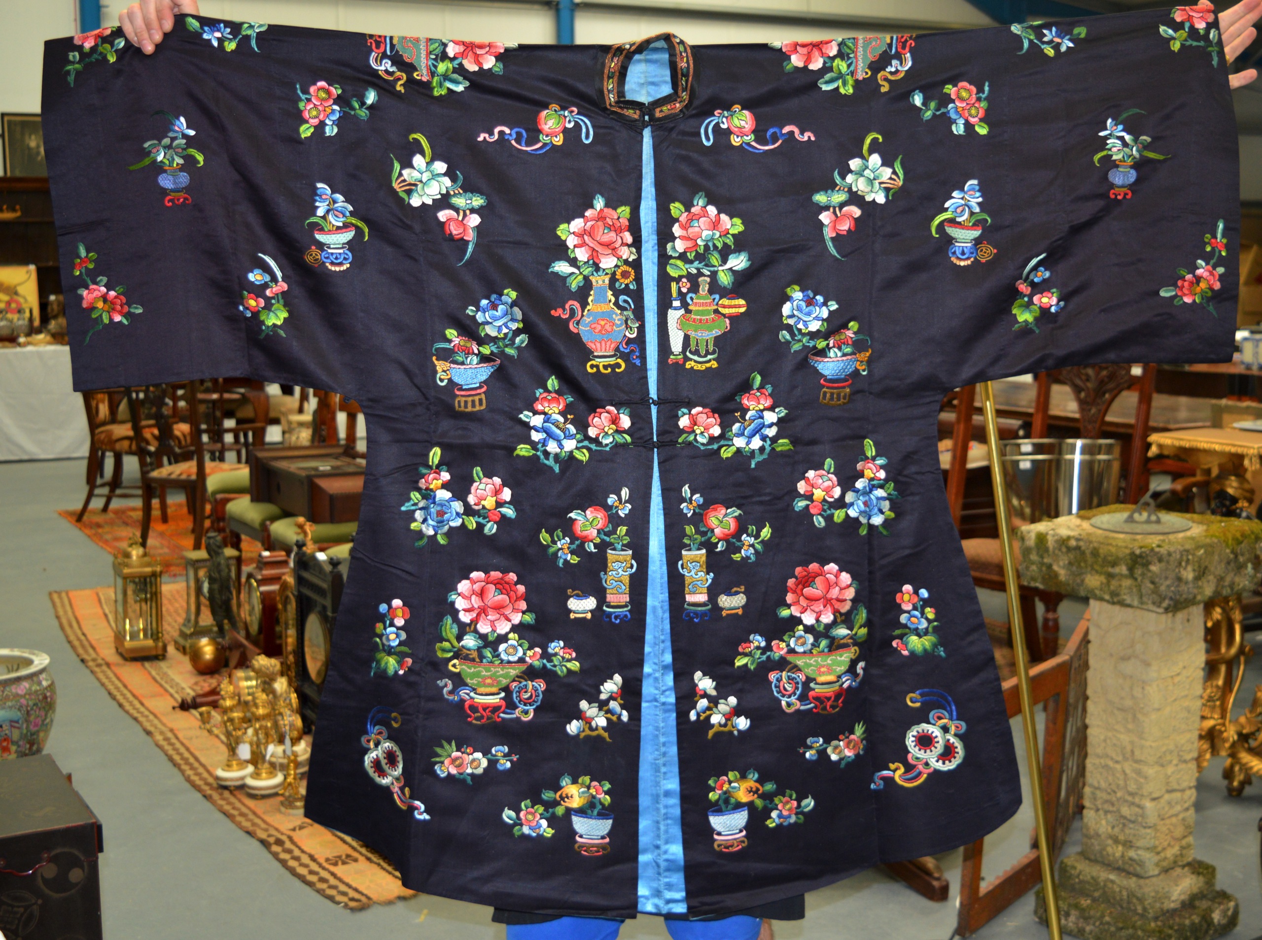 A FINE 19TH CENTURY CHINESE BLUE SILKWORK ROBE decorated in bright colours with flowers, motifs