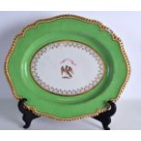 AN EARLY 19TH CENTURY FLIGHT BARR AND BARR PORCELAIN MEAT PLATTER painted with a crest under a green