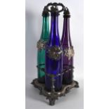 A LATE VICTORIAN/EDWARDIAN SILVER PLATED THREE COLOUR DECANTER SET with plated labels, decorated all