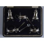 A CASED ENGLISH HALLMARKED SILVER CRUET SET containing condiments, mustard pots etc.