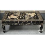AN EARLY 20TH CENTURY CHINESE MOTHER OF PEARL INLAID LOW TABLE decorated with two buddhistic