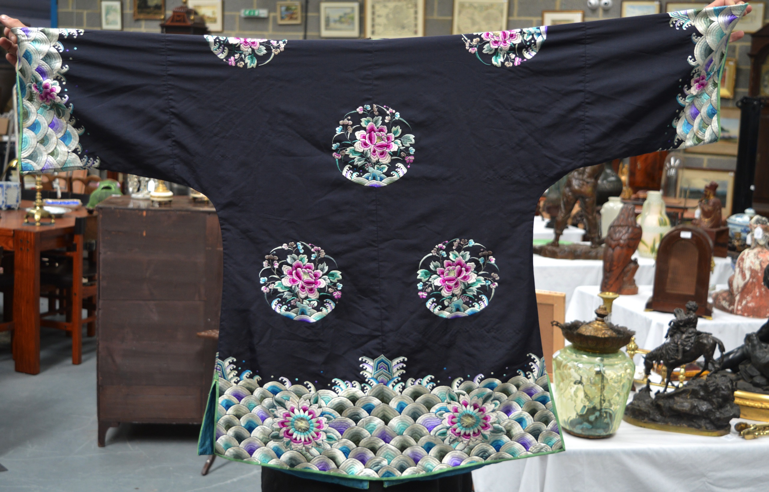 AN EARLY 20TH CENTURY CHINESE BLACK SILKWORK ROBE decorated with panels of flowers, over crashing - Image 5 of 6