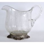 A LATE 19TH CENTURY CONTINENTAL SILVER AND CRYSTAL EWER engraved all over with berries and vines.