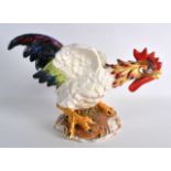 AN ITALIAN FAIENCE TYPE FIGURE OF A COCKEREL. 13.5ins wide.