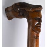 AN EARLY 20TH CENTURY RUSSIAN CARVED WOOD WALKING CANE with twin mask and horse head terminal. 2Ft