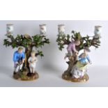 A PAIR OF 19TH CENTURY MEISSEN TWIN BRANCH CANDLEABRA depicting two figures under fruiting vines.