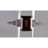 A 9CT EMERALD CUT GARNET AND DIAMOND ART DECO STYLE RING.