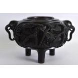 A 19TH CENTURY JAPANESE MEIJI PERIOD TWIN HANDLED BRONZE CENSER decorated in relief with landscapes.