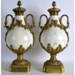 A PAIR OF 19TH CENTURY FRENCH ORMOLU AND WHITE MARBLE URNS AND COVERS with hanging floral vines