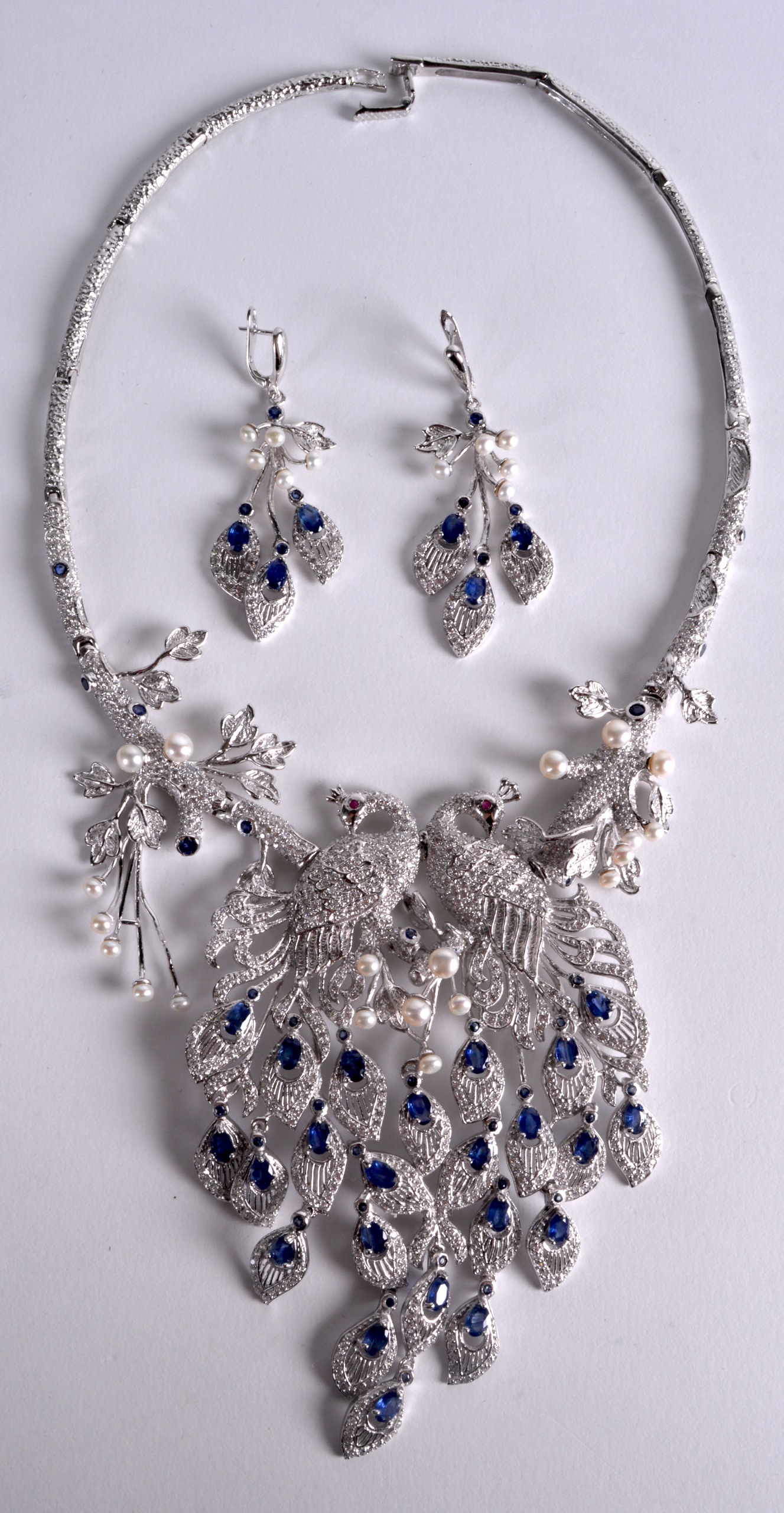 AN ART DECO DESIGN SAPPHIRE, RUBY, PEARL AND CZ PEACOCK NECKLACE AND EARRINGS.