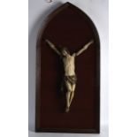 A 17TH/18TH CENTURY POLYCHROMED CARVED WOOD CRUCIFIX modelled upon a velvet lined carved wood frame.