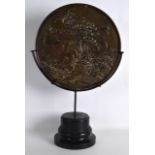 A 19TH CENTURY JAPANESE MEIJI PERIOD BRONZE MIRROR decorated with birds within a landscape,