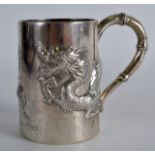 A LATE 19TH CENTURY CHINESE EXPORT SILVER MUG by Wing Sang, decorated in relief with a four claw