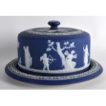 A 19TH CENTURY WEDGWOOD JASPERWARE ½ SIZE CHEESE DISH AND COVER decorated with cupid and other