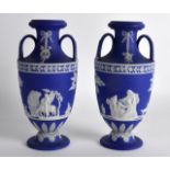 A PAIR OF 19TH CENTURY WEDGWOOD JASPERWARE TWIN HANDLED VASES decorated with figures within