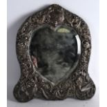A VICTORIAN HEART SHAPED SILVER MOUNTED MIRROR decorated with birds and scrolling foliage. 9.5ins