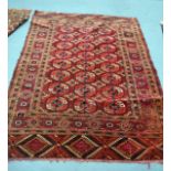 A RED GROUND PERSIAN RUG decorated with medallions within a floral border. 5Ft 10ins x 4ft 4ins.