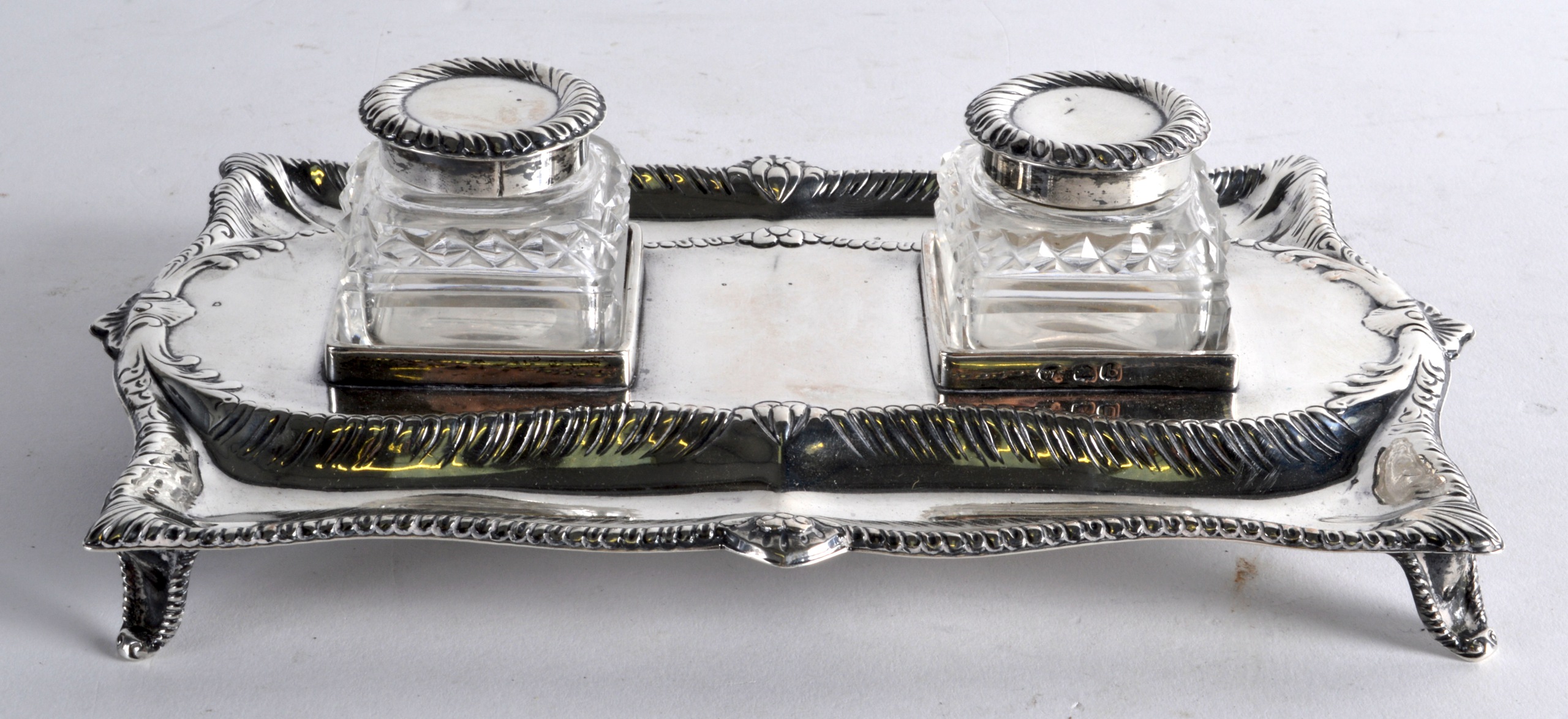 A GEORGE III SILVER GENTLEMANS DESK INKWELL. London 1777. 12oz. 8.25ins wide.