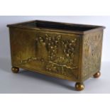 AN ARTS AND CRAFTS ENGLISH BRASS RECTANGULAR PLANTER decorated in relief with birds. 1Ft 1ins wide.