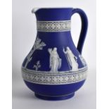 A 19TH CENTURY WEDGWOOD JASPERWARE JUG decorated with classical figures under a floral lattice