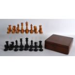 AN EARLY 20TH CENTURY BOXWOOD AND EBONISED WOOD CHESS SET contained within a wooden box.