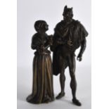 A 19TH CENTURY EUROPEAN BRONZE FIGURAL GROUP depicting the devil standing beside a courting