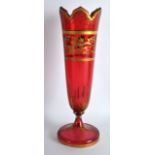 A LATE 19TH CENTURY BOHEMIAN RUBY GLASS VASE highlighted in gilt with scrolling foliage. 1Ft 1.