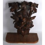 A LATE 19TH CENTURY BAVARIAN BLACK FOREST CARVED WOOD WALL BRACKET decorated with two mountain