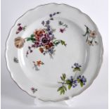 AN 18TH CENTURY CHELSEA PORCELAIN SCALLOPED DISH painted with flowers under a brownish rim. 8.