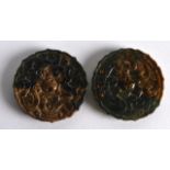 A PAIR OF CHINESE CARVED GREEN JADE TOGGLES each decorated with stylised chilong. 2Ins diameter.